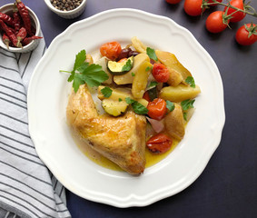 Golden crispy chicken leg with oven vegetables.