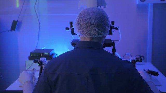 In a Modern Laboratory Scientist Conduct Experiments. The embryologist Examines Samples with a Microscope