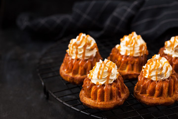 Homemade carrot cupcakes with caramel sauce and cream cheese frosting