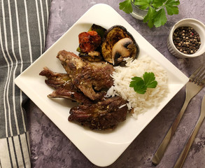 Grilled lamb chops and fresh vegetables with herbs and rice.