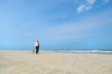 Business man with dog at the beach