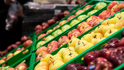 Basket with fresh ripe green apple fruits on sale in grocery food store.Supermarket shop,natural foods department.Eat vitamines