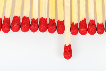 matches with a red head on a white background