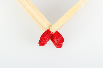 matches with a red head on a white background