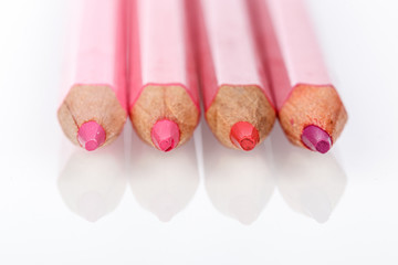 red, pink, yellow pencil on a white background