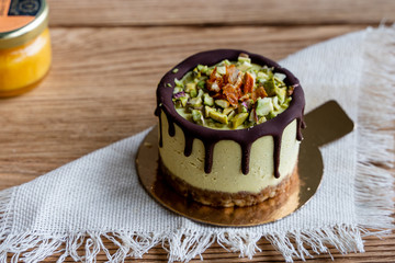 Raw healthy dessert. Orange cake with chocolate. Wooden background.