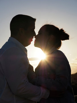 Pareja a punto de besarse al atardecer 