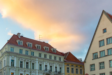 Bright colourful sunset sky over the elaborate merchant houses on Raekoja plats in the old town of Tallinn, Estonia, Europe. The Town hall square is a venue for open-air concerts, fairs, markets.