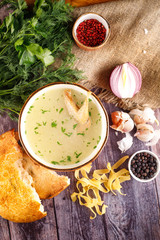 chicken soup in a bowl with a bag