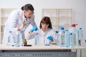 Two chemists working in the lab