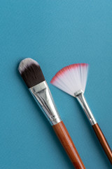 Apparatus and tools for ultrasonic cleaning. Personal hygiene and health concept. Flat lay. Brushes Tools for mechanical cleaning of the face on a blue background. Facial peeling and beauty treatments