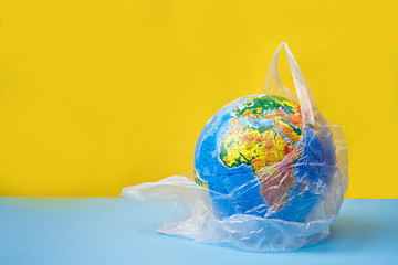 Earth planet in a plastic, eco no plastic concept, globe in plastic.