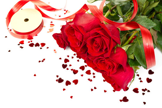 freshly cutted red roses with hearts forming a frame on white background. copy space. Flowers, womens day, mother day, Birthday or st Valentine concept