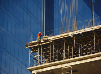 Worker in high skycraper, safety concept