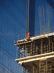 Worker in high skycraper, safety concept