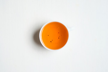 Cup of tea on a white wooden background. Top view.
