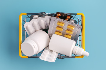 Shopping basket with medicinal pills and tablets closeup. Top view