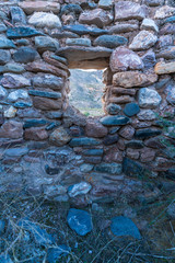 stone wall with a small window