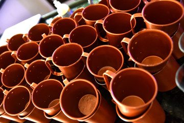 several empty and stacked golden metal mugs ideal for drinks