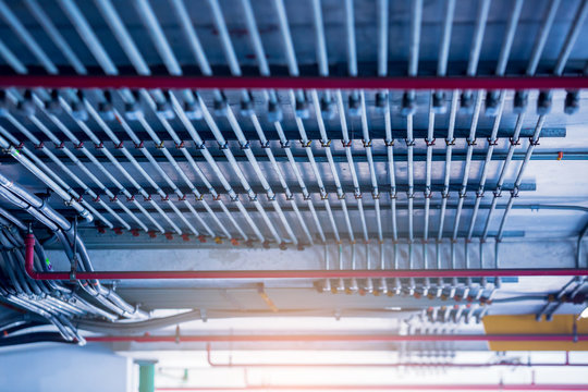 Blurry picture of electrical conduit and cabling. Blurry image for construction background. The rows of electrical conduit and signal cables in the parking building.