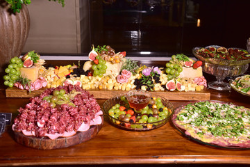 delicious and tasty smoked ham and sliced ​​parma ham served on the table with side dishes on blurred background