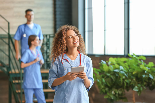 Female African-American Medical Student With Tablet Computer In Clinic