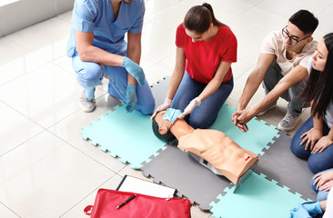 Group of people with instructor at first aid training course