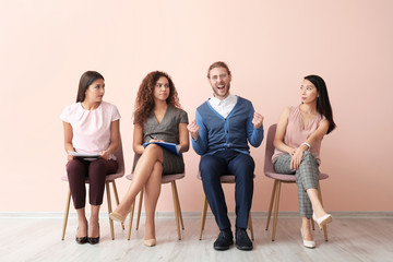 People looking at happy man  who has successfully passed job interview