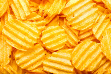 Tasty potato chips as background