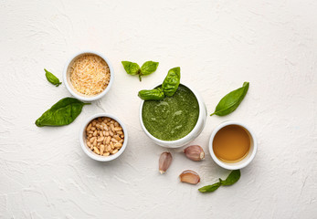 Pesto sauce with ingredients on white background