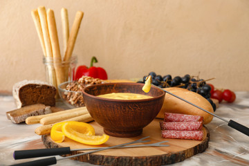 Cheese fondue with snacks on table
