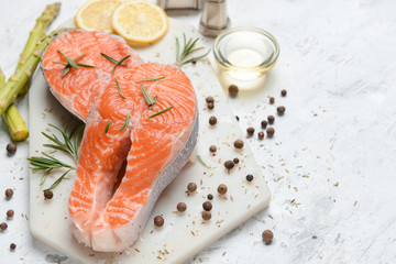 Raw salmon steaks and spices on table