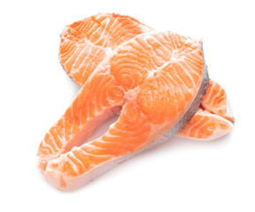 Raw salmon steaks on white background