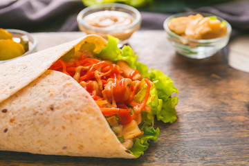 Tasty doner kebab on table, closeup