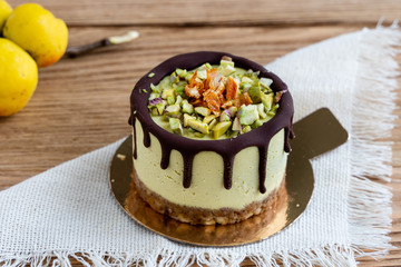 Raw healthy dessert. Orange cake with chocolate. Wooden background