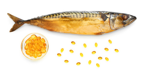 Fish with oil pills on white background