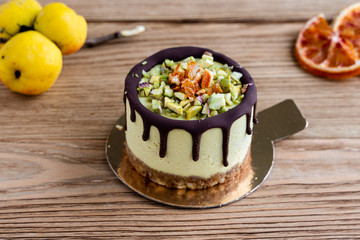 cake with fruits. Raw healthy dessert. Orange cake with chocolate. Wooden background