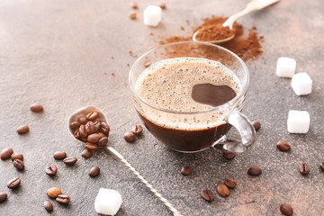 Cup of hot coffee on grey background