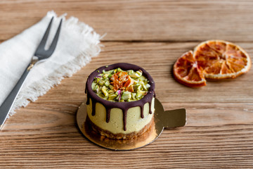  Raw healthy dessert. Orange cake with chocolate. Wooden background