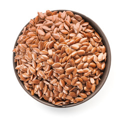 Bowl with flax seeds on white background