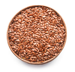 Bowl with flax seeds on white background
