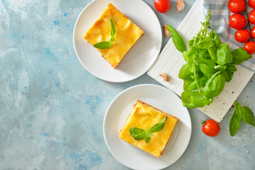 Plates with tasty homemade lasagna on table