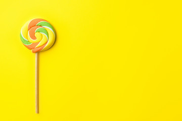 Tasty lollipop on color background