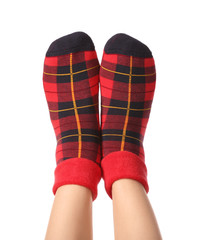 Legs of young woman in socks on white background