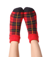 Legs of young woman in socks on white background
