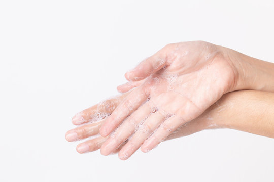 Asian girl hands are washing with soap bubbles on white background.