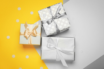 Beautiful gift boxes on color background
