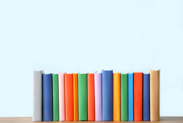 Many books on table against light background
