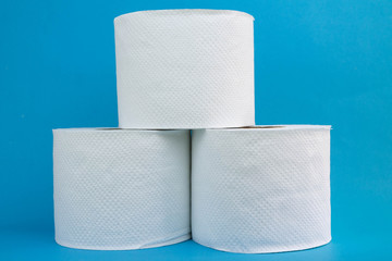 Toilet paper on blue bathroom background