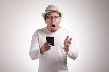 Young Man Texting Reading Chatting on His Phone Surprised Gesture